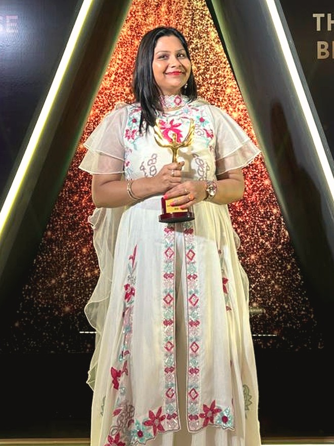 Tripti Agarwal, Life & Relationship Coach, holding an award